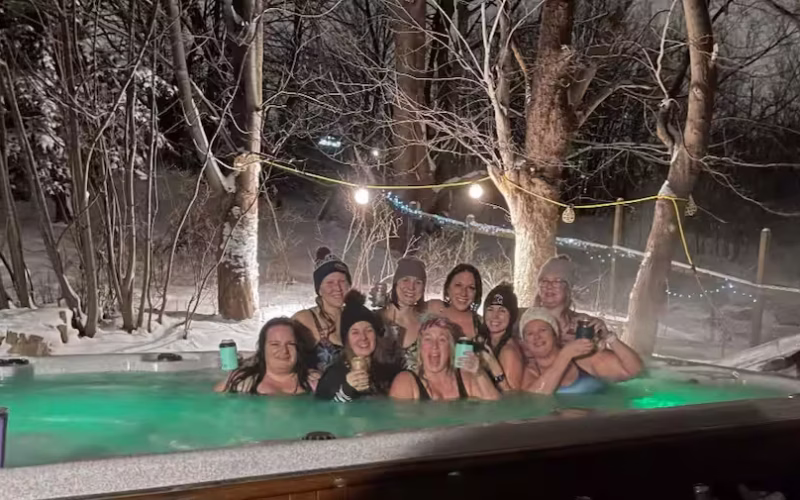 Guests relaxing in the outdoor hot tub