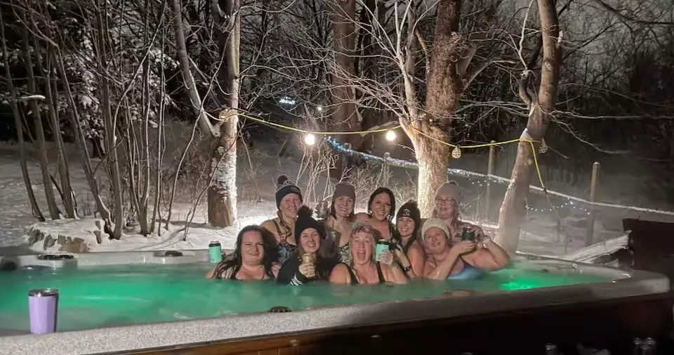 Guests enjoying the outdoor hot tub at Westport Manor